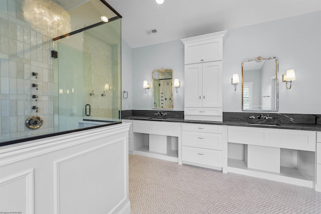 bathroom with vanity, an enclosed shower, and tile patterned flooring