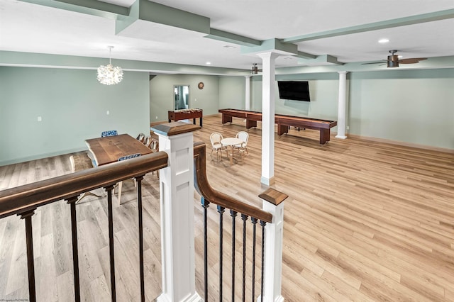 interior space with light hardwood / wood-style flooring, pool table, and ceiling fan with notable chandelier