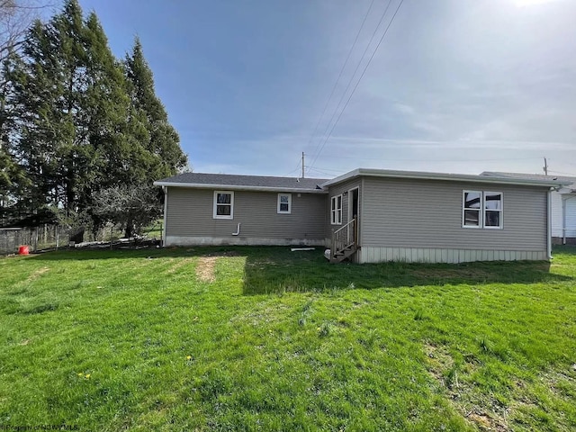 rear view of house with a lawn