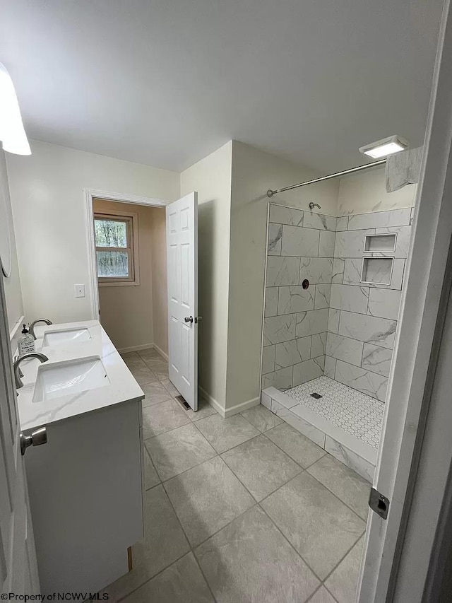 bathroom featuring vanity and a tile shower