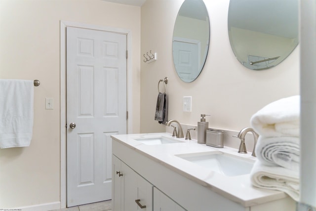 bathroom featuring tile patterned flooring and vanity