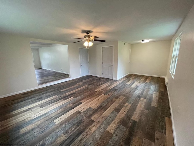 empty room with dark hardwood / wood-style floors and ceiling fan