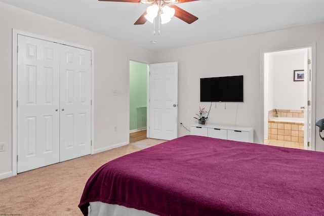 carpeted bedroom with a closet, ceiling fan, and connected bathroom