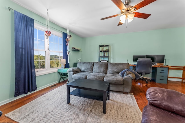 living room featuring ceiling fan and hardwood / wood-style flooring