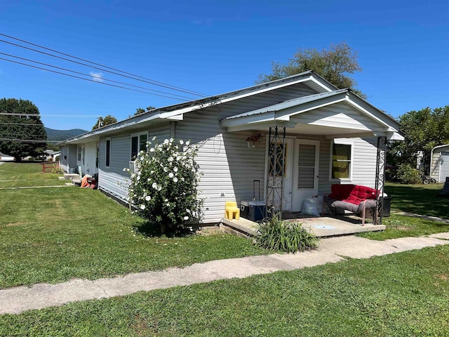 view of front of house with a porch and a front lawn