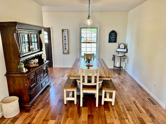 dining space with wood-type flooring