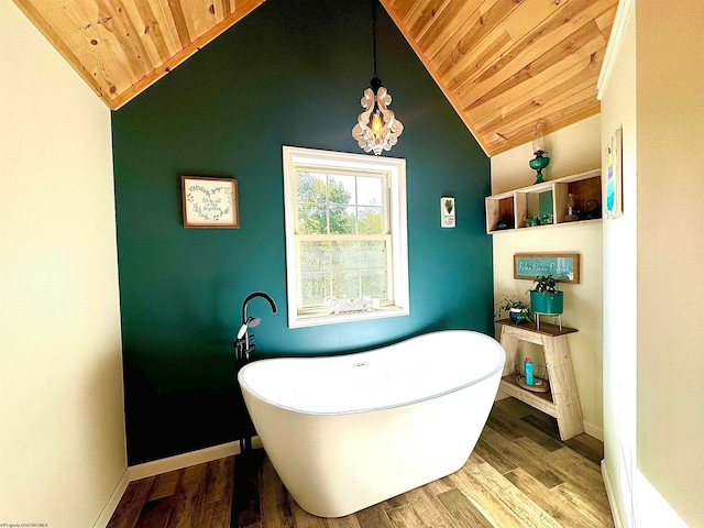 bathroom featuring lofted ceiling, a bathing tub, hardwood / wood-style floors, and wooden ceiling