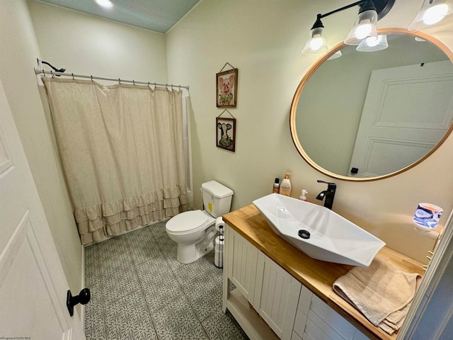 bathroom featuring vanity, toilet, and curtained shower