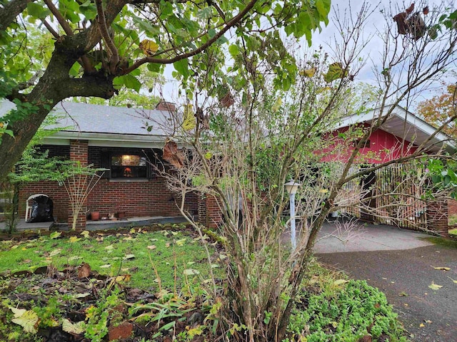 413 Green Acres Cir, Spencer, WV 25276 - exterior space with aphalt driveway and brick siding