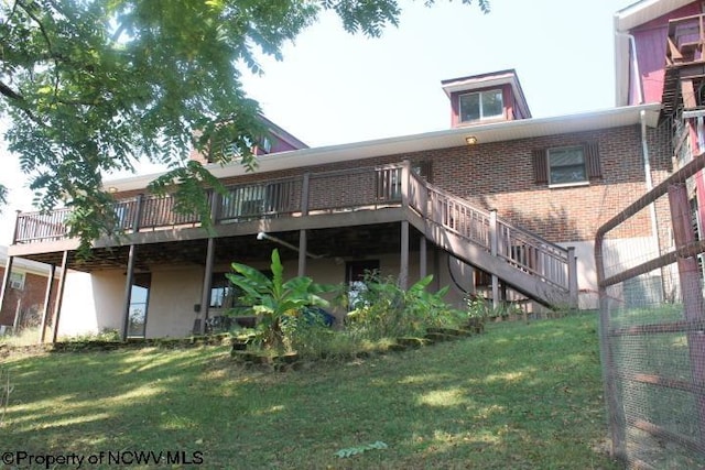 413 Green Acres Cir, Spencer, WV 25276 - back of house featuring stucco siding, a deck, a yard, stairway, and brick siding