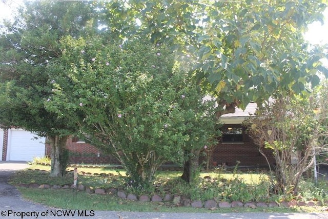 413 Green Acres Cir, Spencer, WV 25276 - view of front of property featuring a garage and brick siding