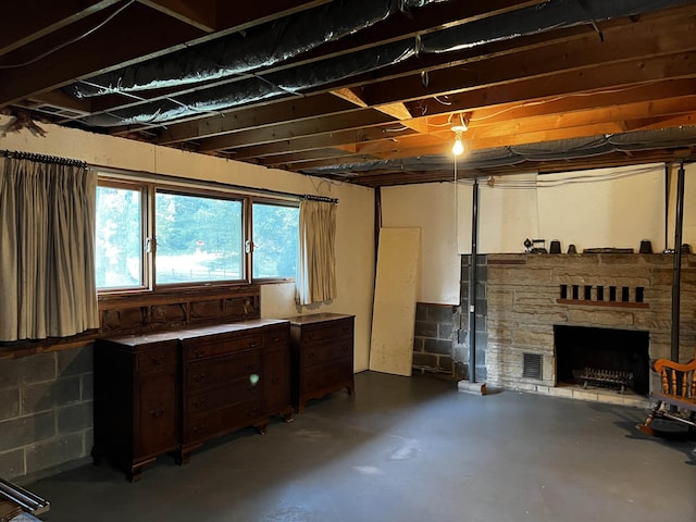 basement featuring a stone fireplace