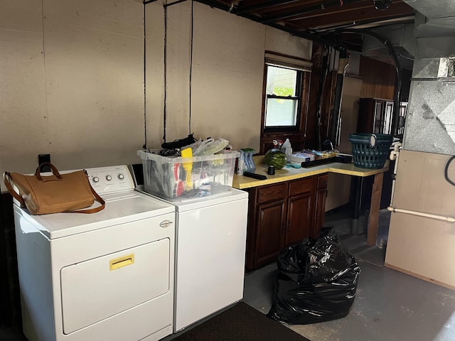 washroom with cabinets and washer and dryer