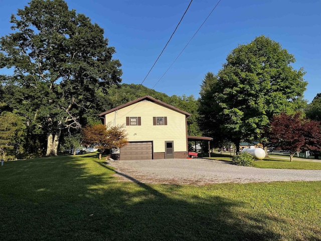 view of home's exterior with a garage and a yard