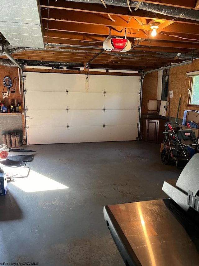 garage with electric panel and a garage door opener