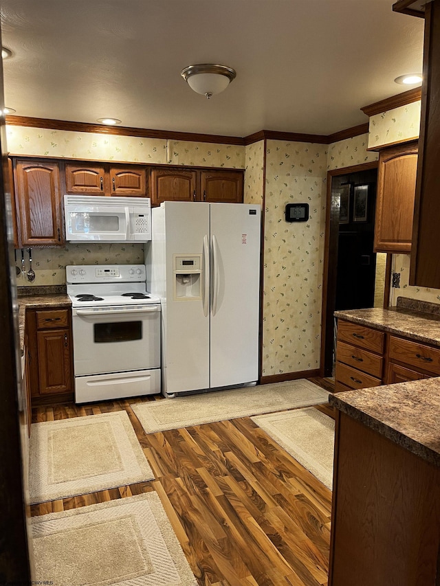 kitchen with crown molding, white appliances, and light hardwood / wood-style flooring