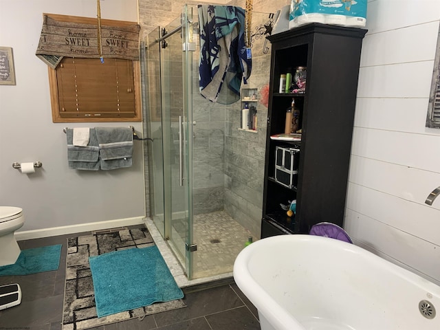 full bathroom with a stall shower, toilet, tile patterned flooring, baseboards, and a freestanding bath