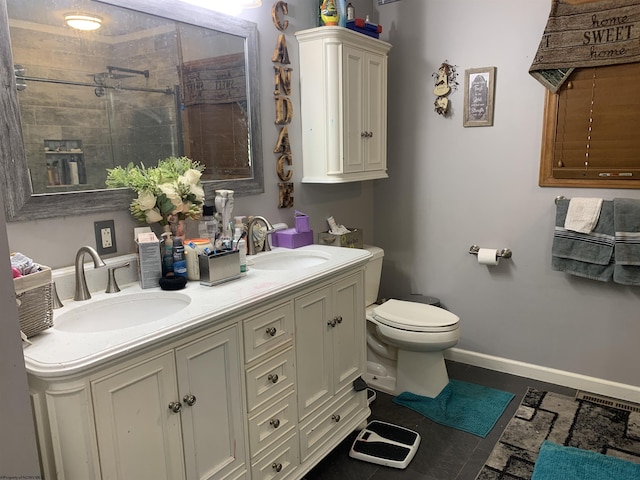 full bath with toilet, a sink, baseboards, and a shower stall