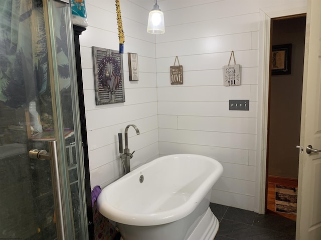 full bath featuring tile patterned flooring and a soaking tub