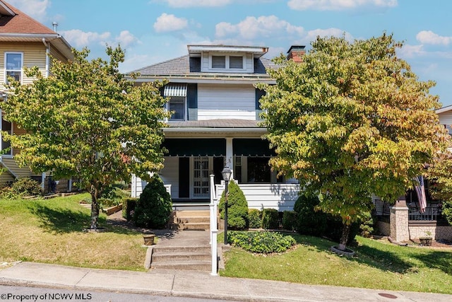 view of front of house featuring a front lawn and covered porch