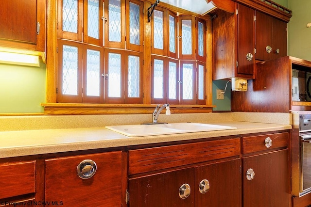 kitchen with built in microwave, plenty of natural light, and sink