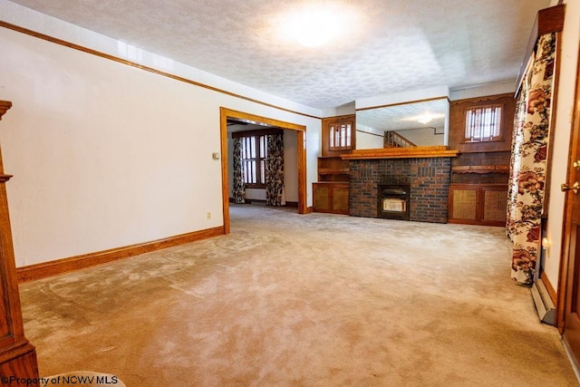 unfurnished living room with a textured ceiling, a brick fireplace, and carpet