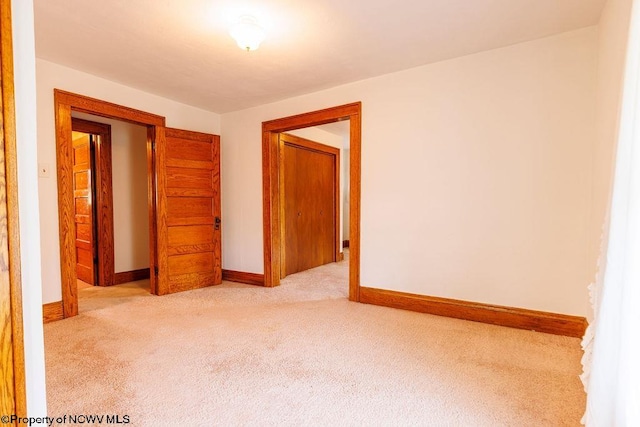 empty room featuring light colored carpet