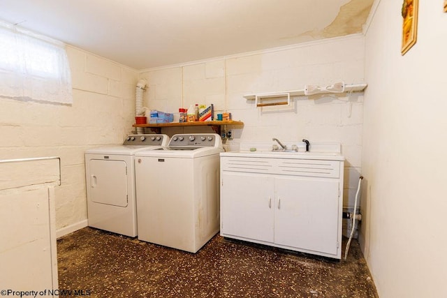 clothes washing area with washing machine and dryer