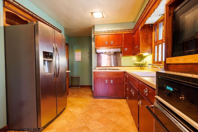 kitchen with stainless steel fridge with ice dispenser, sink, and oven