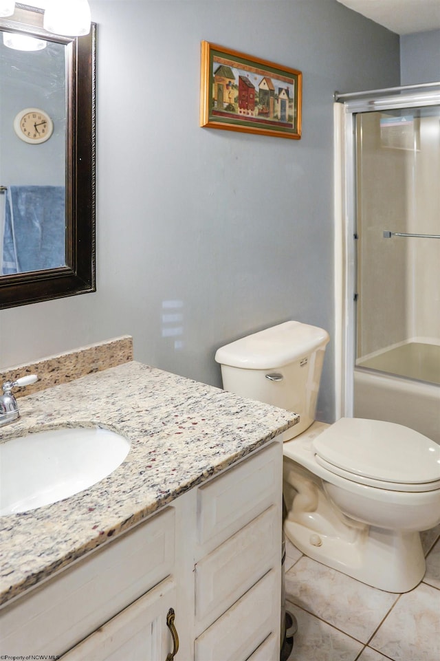 full bathroom featuring vanity, toilet, tile patterned floors, and bath / shower combo with glass door