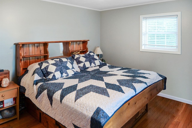 bedroom featuring crown molding and hardwood / wood-style flooring