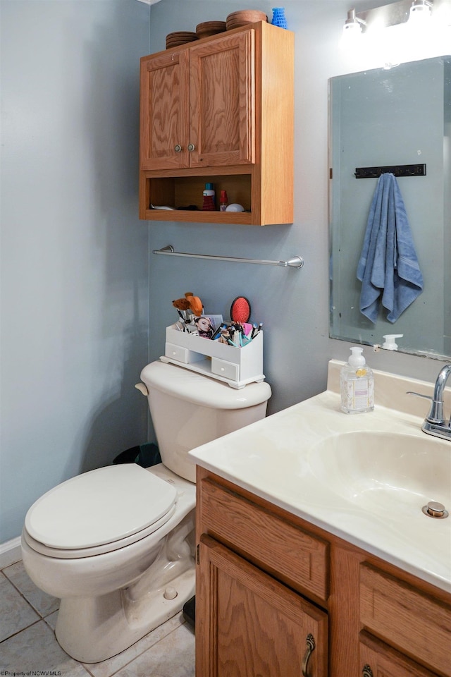 bathroom featuring tile patterned floors, toilet, and vanity