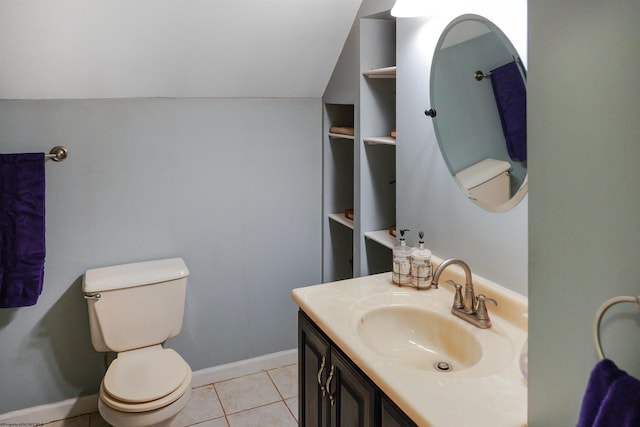 bathroom with tile patterned floors, vaulted ceiling, toilet, and vanity