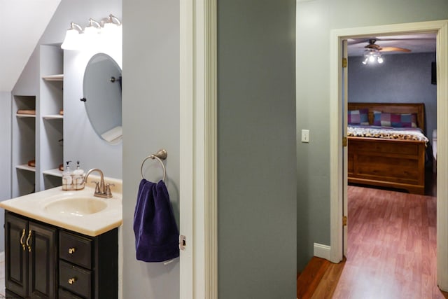 bathroom with vanity, hardwood / wood-style flooring, and ceiling fan