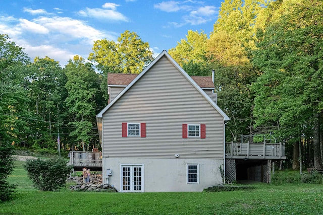 view of home's exterior with a yard and a deck