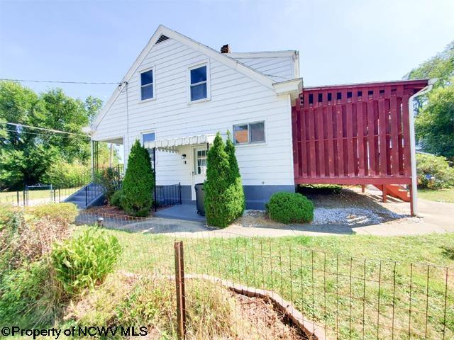 view of side of home with fence