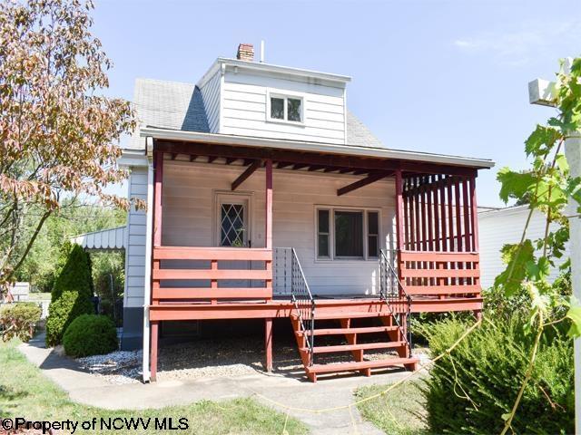 view of front of home with a porch and a chimney