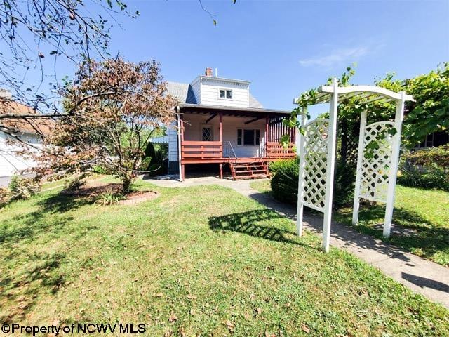 rear view of property featuring a yard