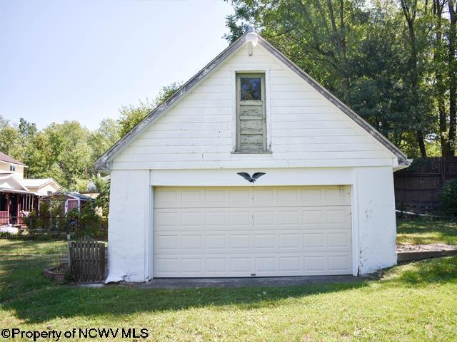 detached garage featuring fence