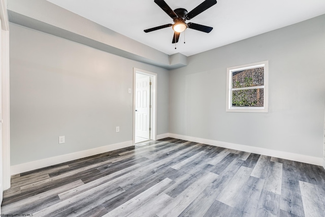 spare room with hardwood / wood-style flooring and ceiling fan