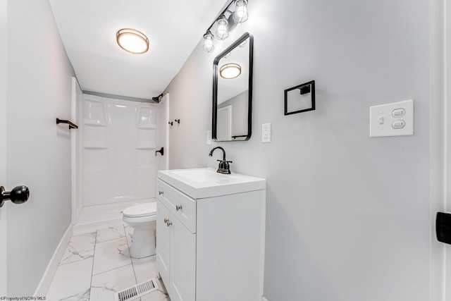 bathroom featuring vanity, toilet, and walk in shower