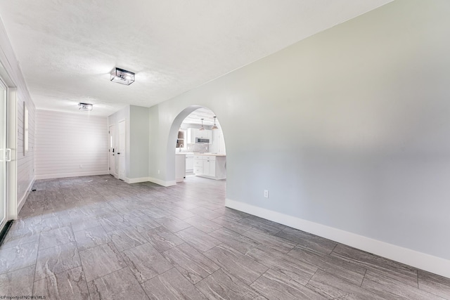 spare room with a textured ceiling