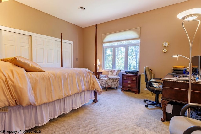 bedroom featuring light colored carpet, visible vents, and a closet