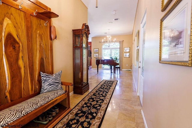 corridor with a chandelier and baseboards