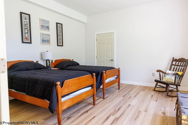 bedroom featuring light wood-type flooring and baseboards