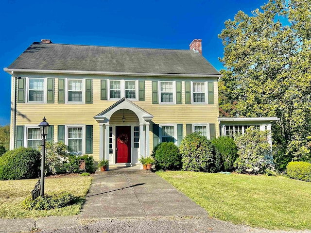 colonial-style house with a front yard