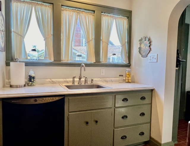 kitchen featuring black dishwasher, a healthy amount of sunlight, arched walkways, and a sink