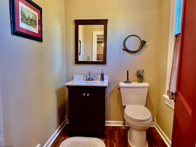 bathroom featuring vanity, toilet, and wood-type flooring