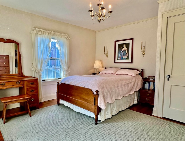 bedroom featuring wood-type flooring and an inviting chandelier