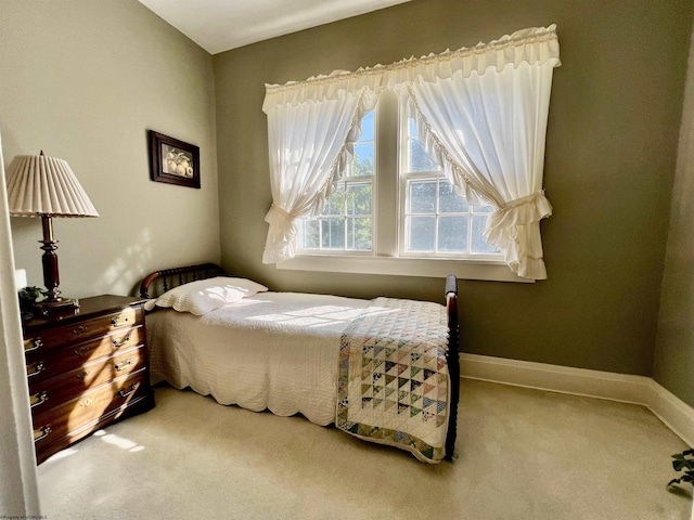 carpeted bedroom featuring baseboards